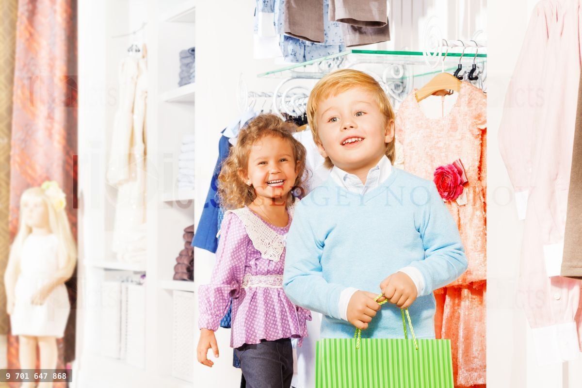 Boy with shopping bag and laughing girl behind him