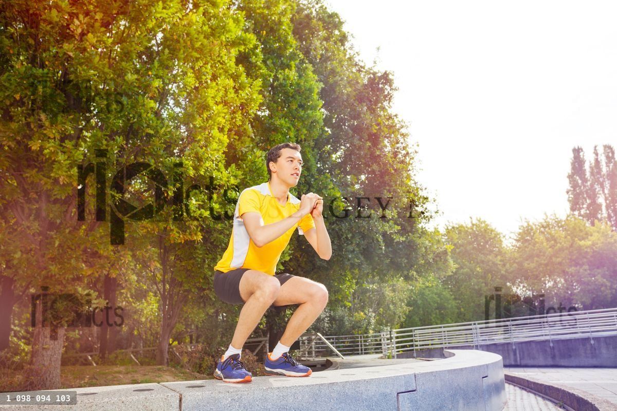 Young athlete performing jumps outdoors at park