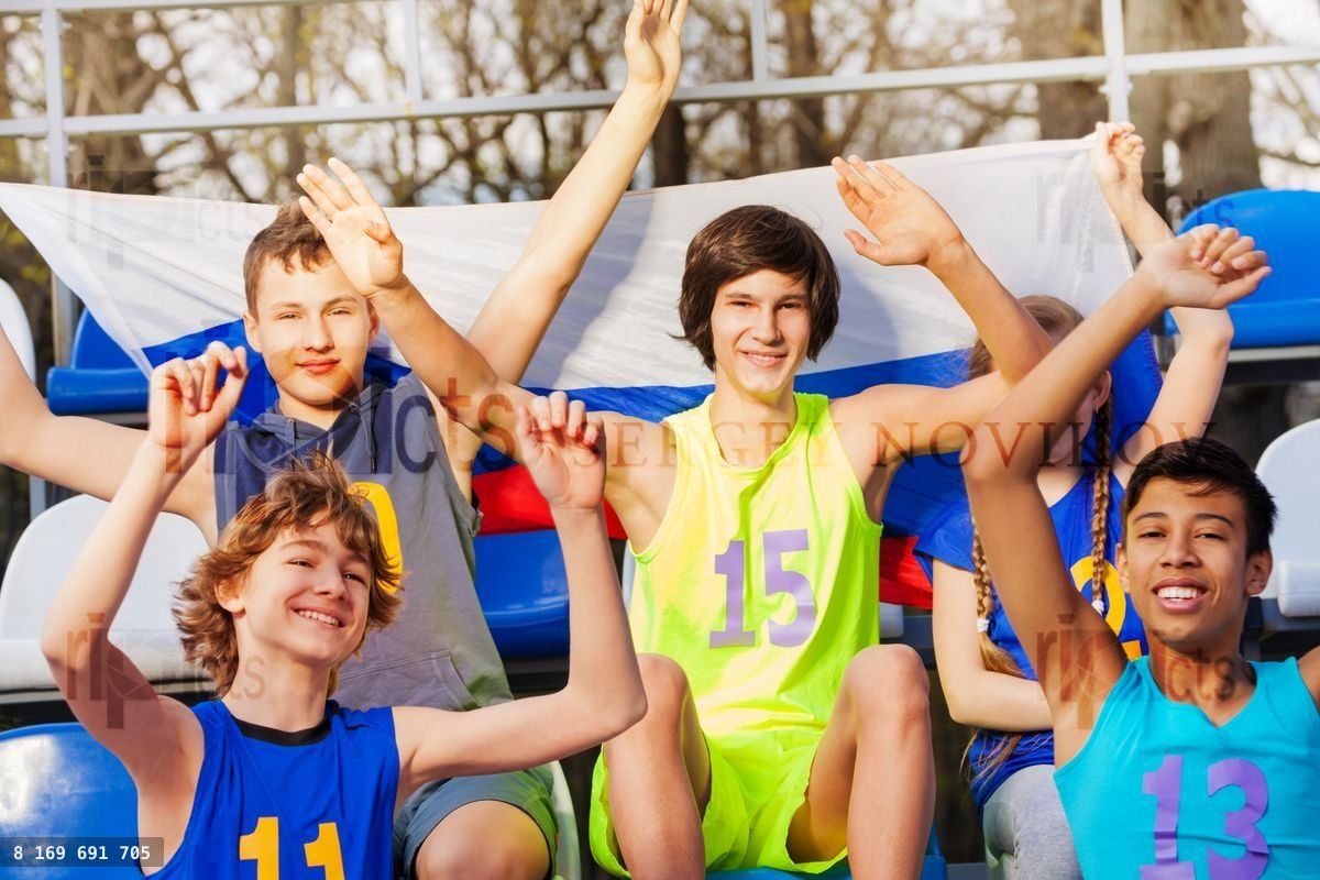 Group of sport supporters at the stadium's tribune