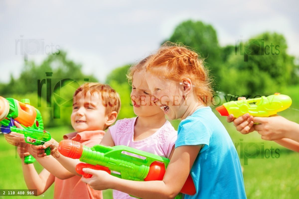 Funny kids playing with water guns