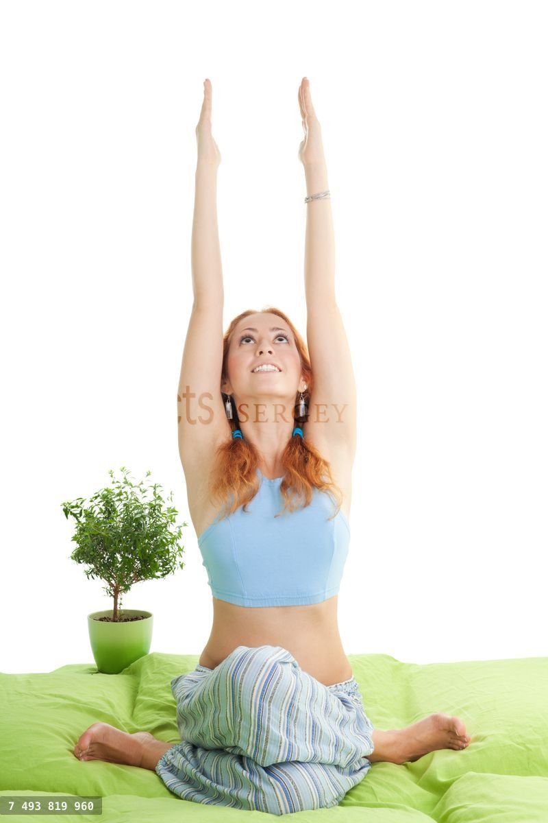 woman with red hair do yoga exercises