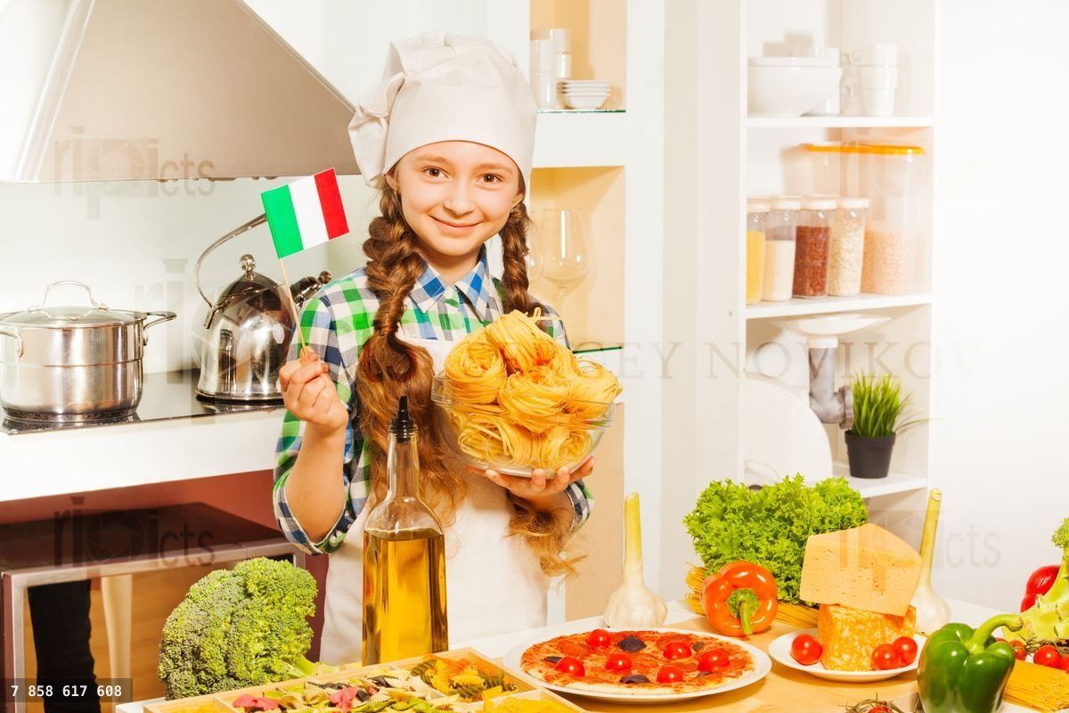 Young chief cook making Italian pasta at kitchen