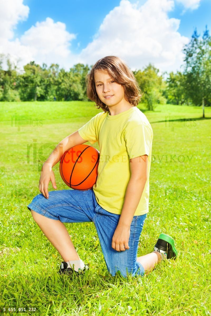 Boy with basketball posing