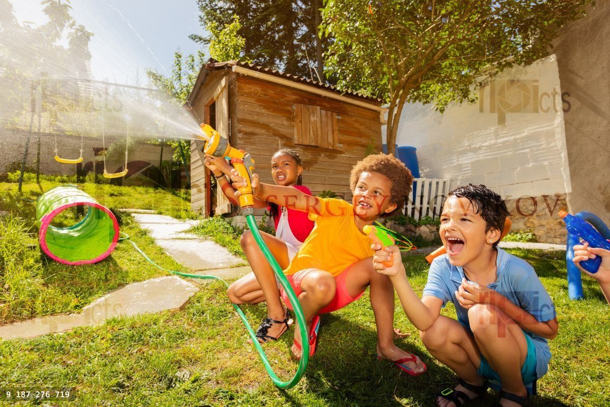 Fun with water guns and garden hose sprinkler
