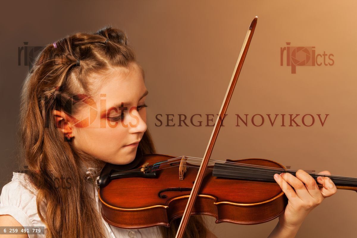 Half face view of beautiful girl playing violin