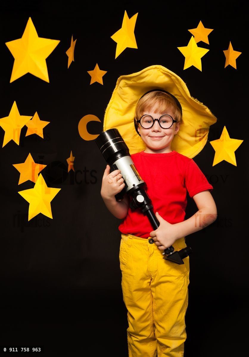 Young stargazer with telescope against starry sky