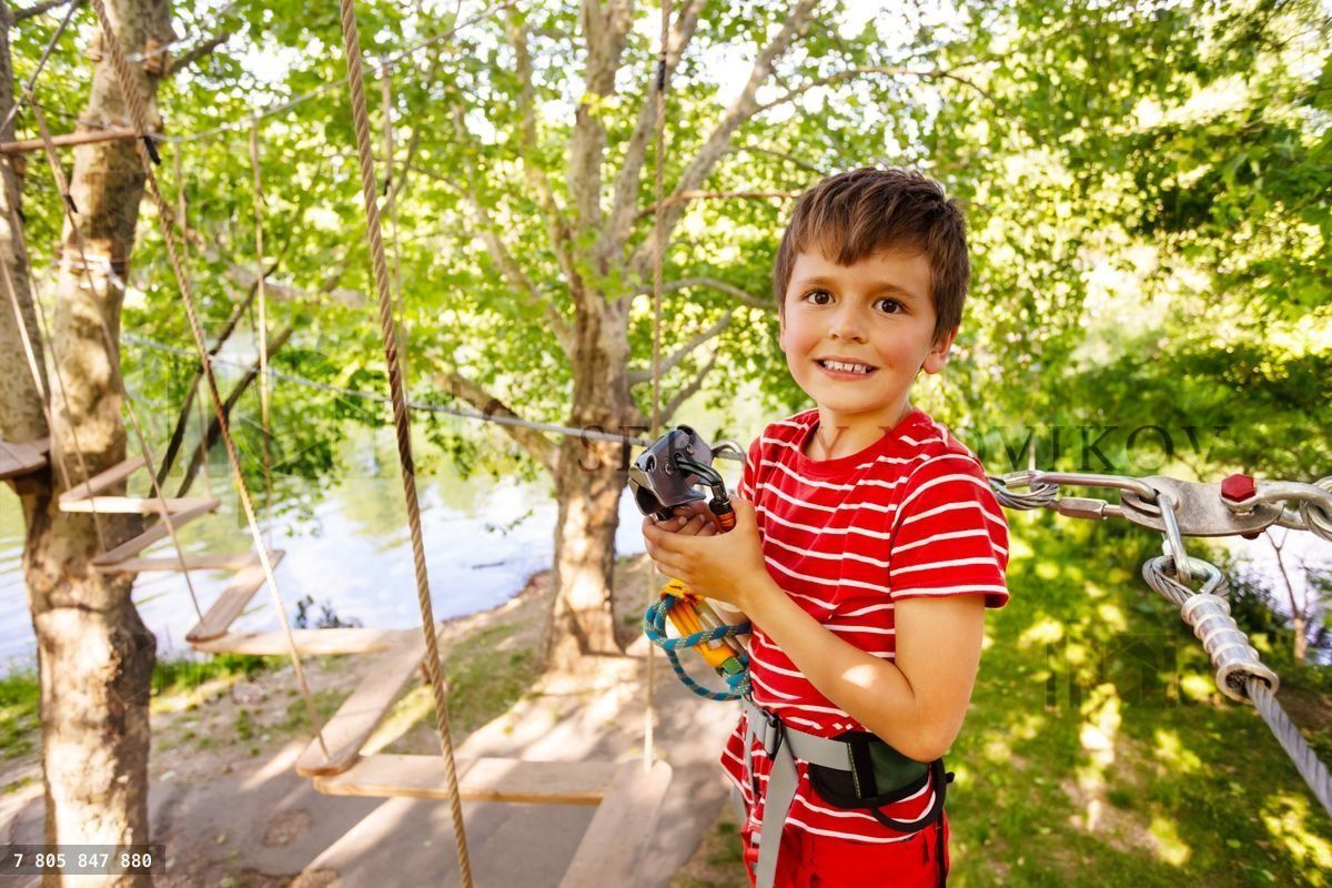 Boy with climbing equipment portrait near zip line