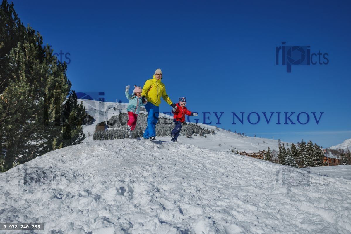Snowy adventure of family, it jumps and plays outdoors in winter