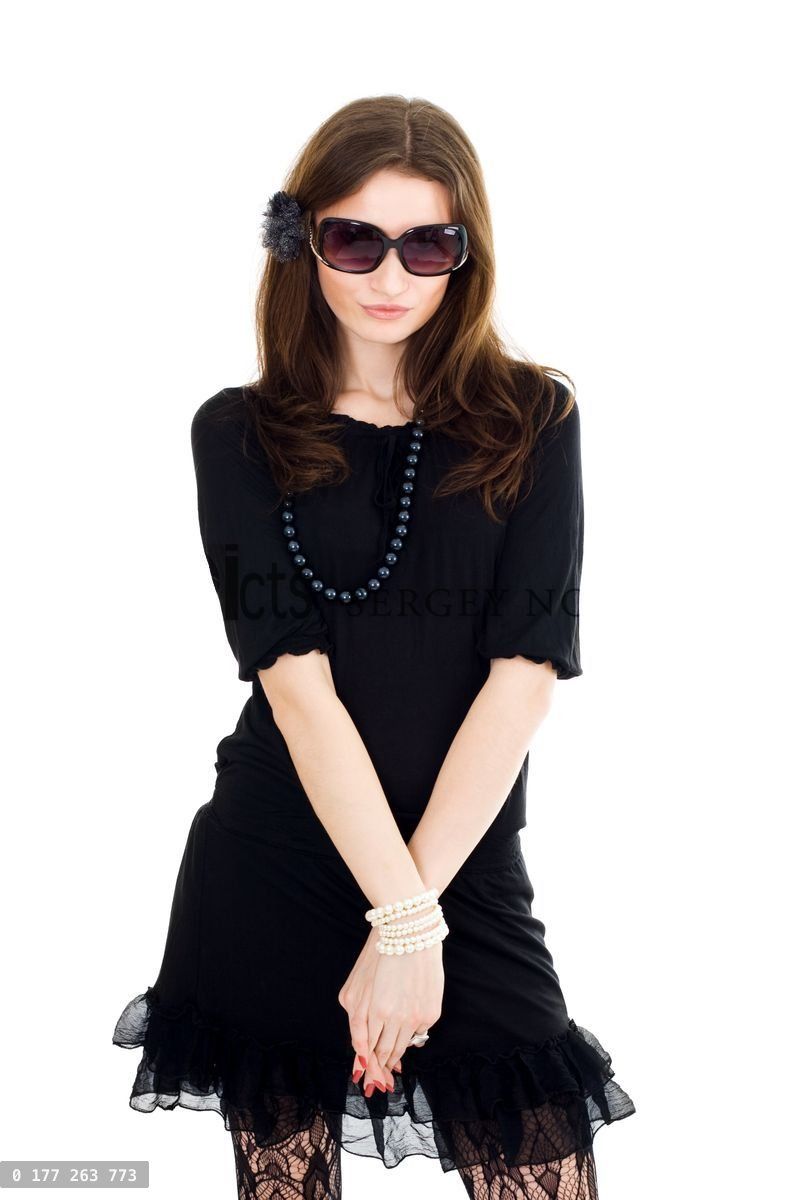 Woman in black dress and sunglasses