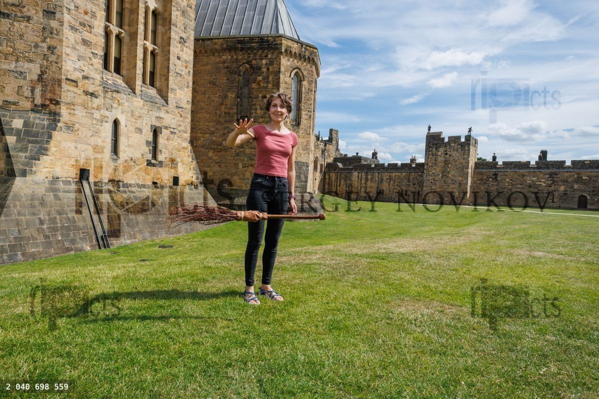Young woman pretend making flying a broom in historic castle