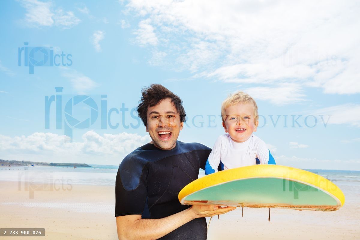 Fun with surfboard, father and son on the ocean