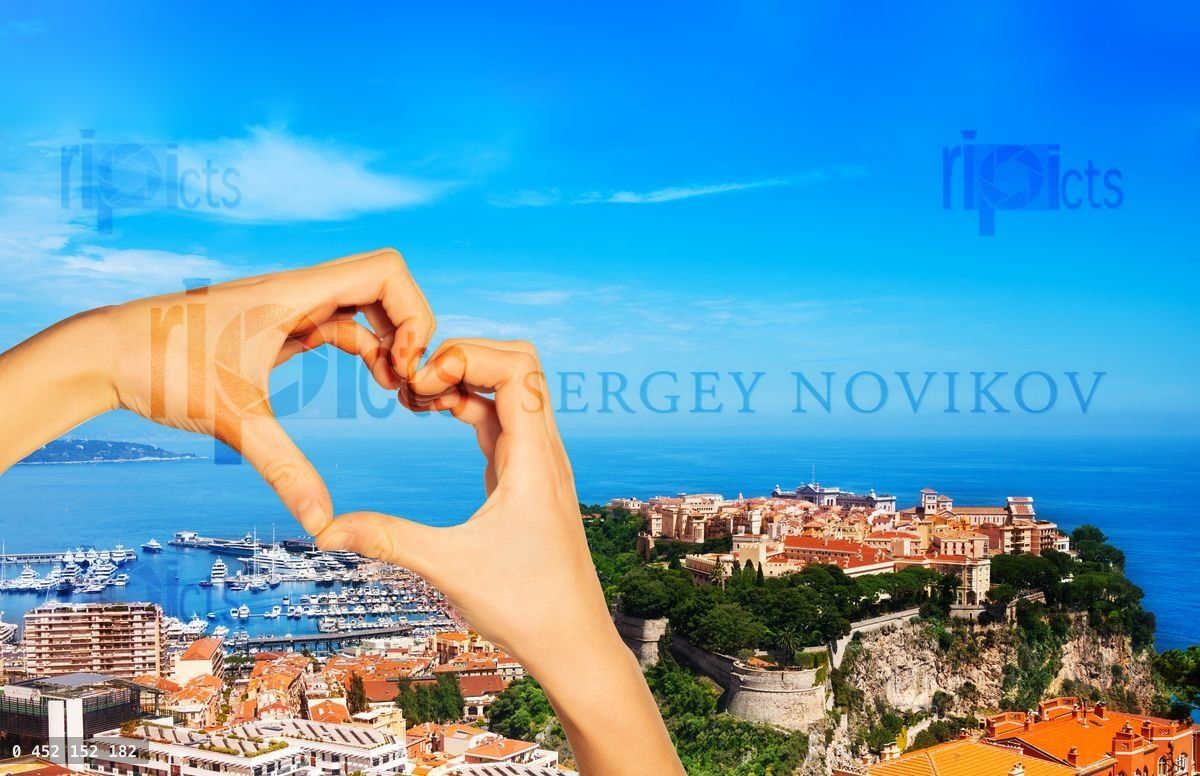 Hand hold red heart over old city, palace Monaco