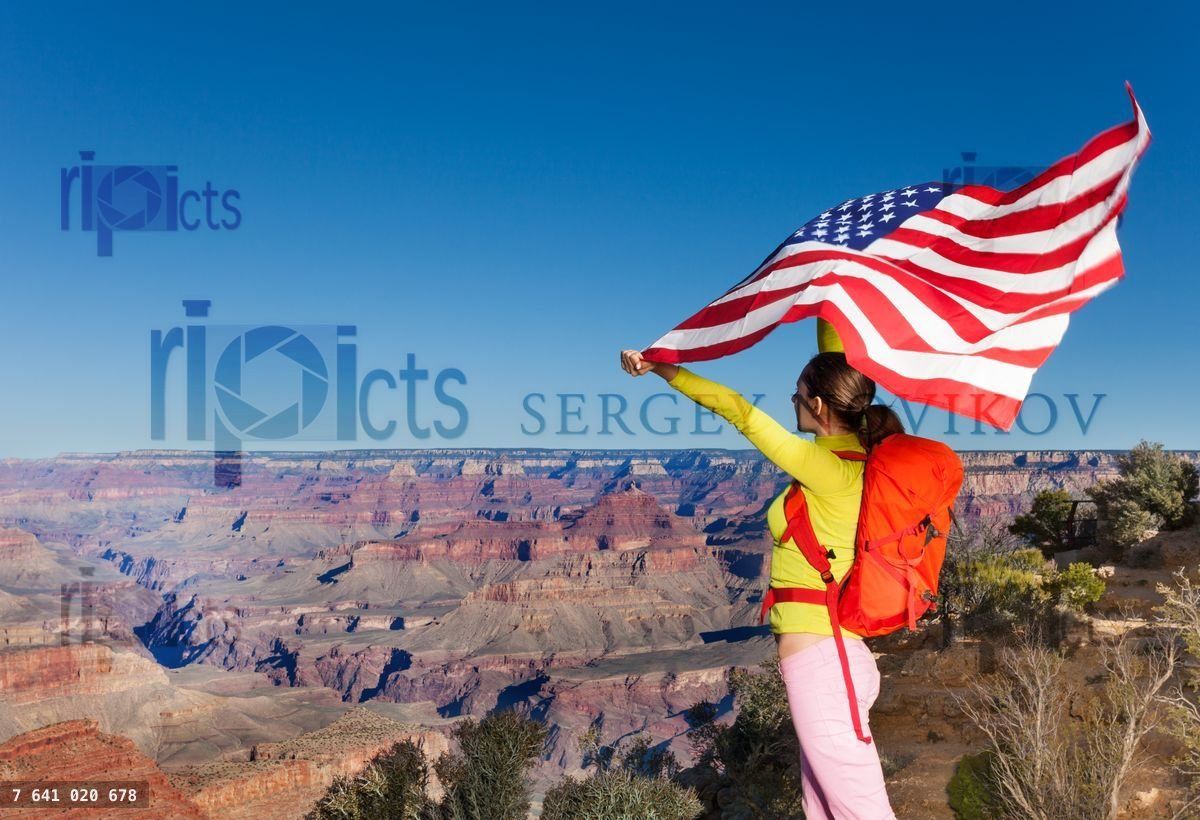 Woman holding US flag, Grand Canyon National Park