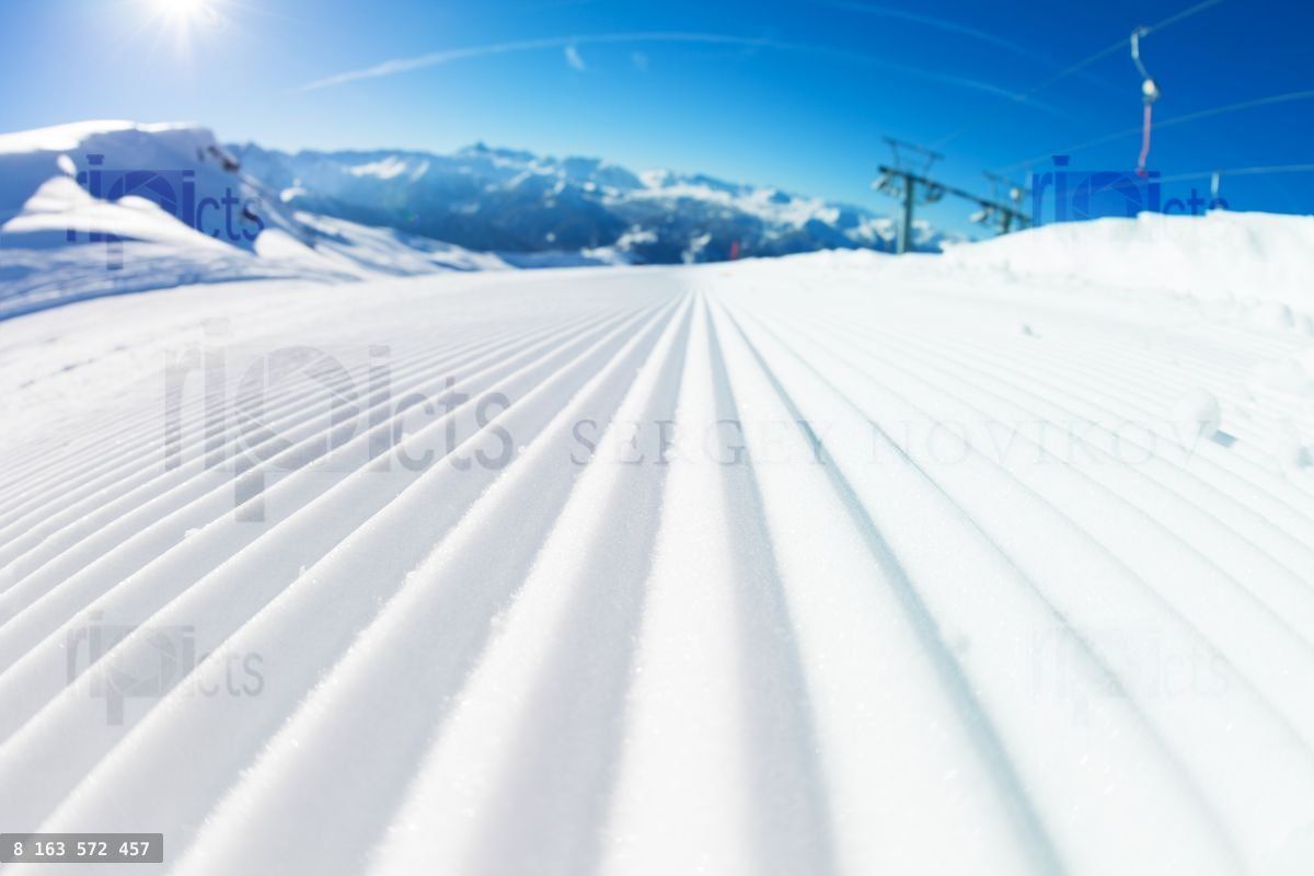 Fresh tracks of snowcat at snowcapped slopes