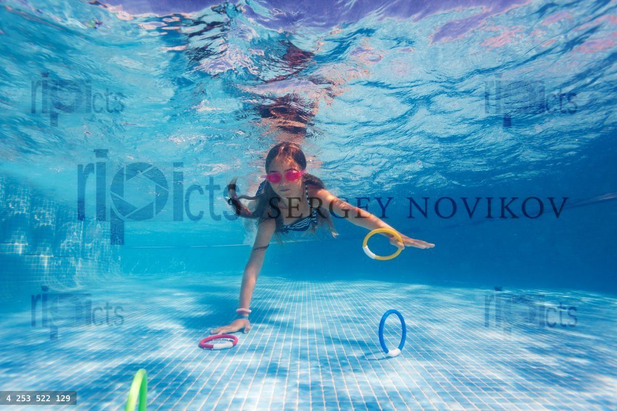 Girl exercising during underwater swimming lesson