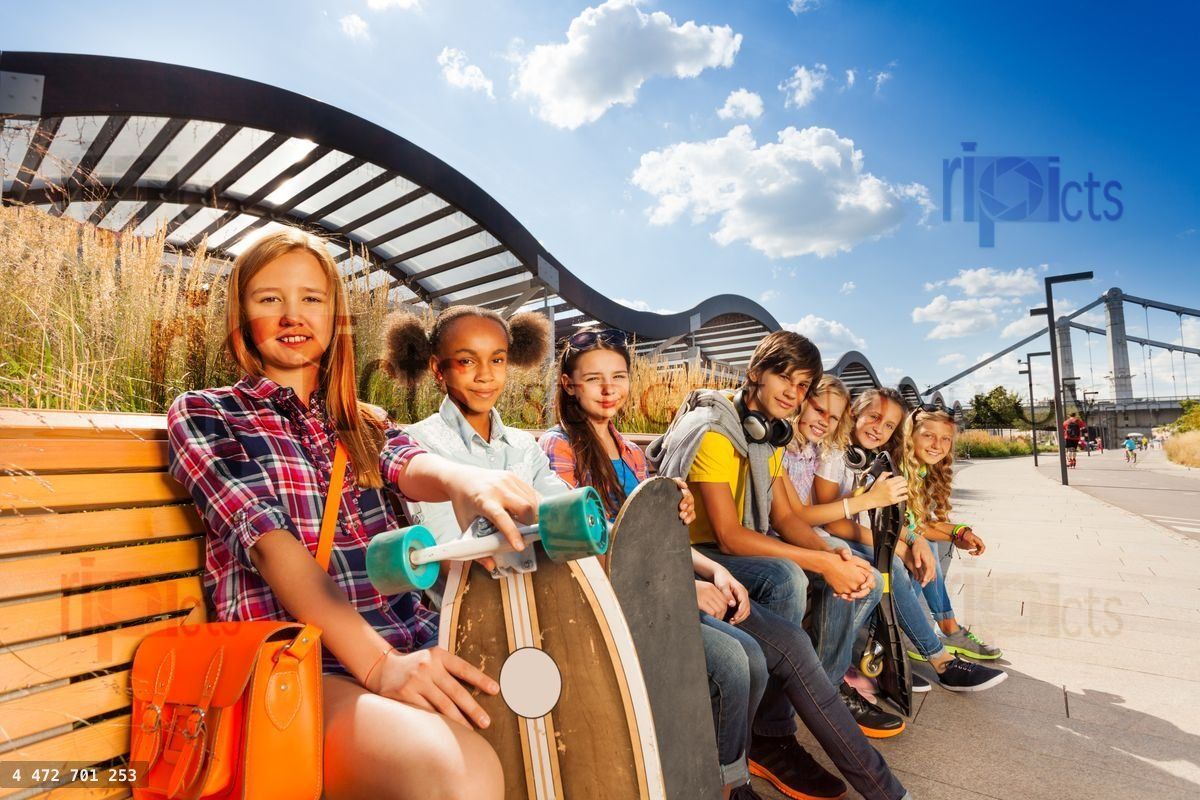 Group of children sitting on wooden bench together