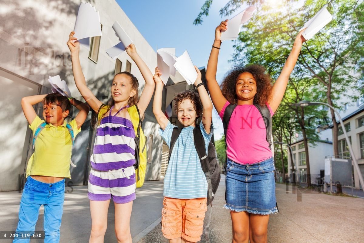 Group of kids showing papers in the air