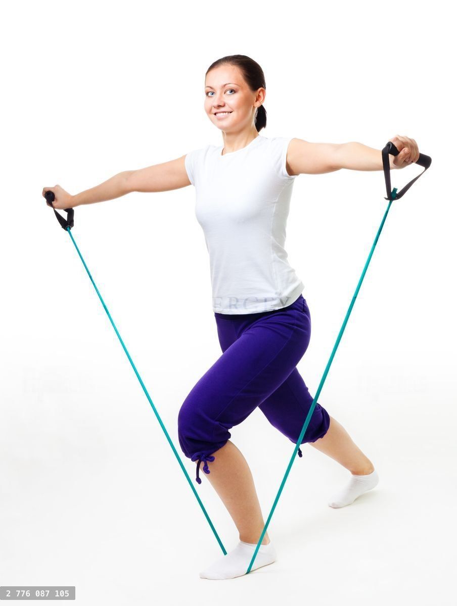 Young woman doing fitness with expander