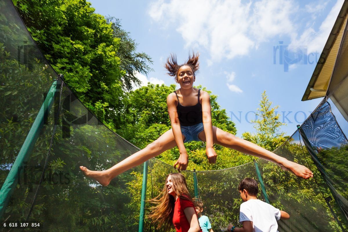 Girl having fun with her friends on the trampoline