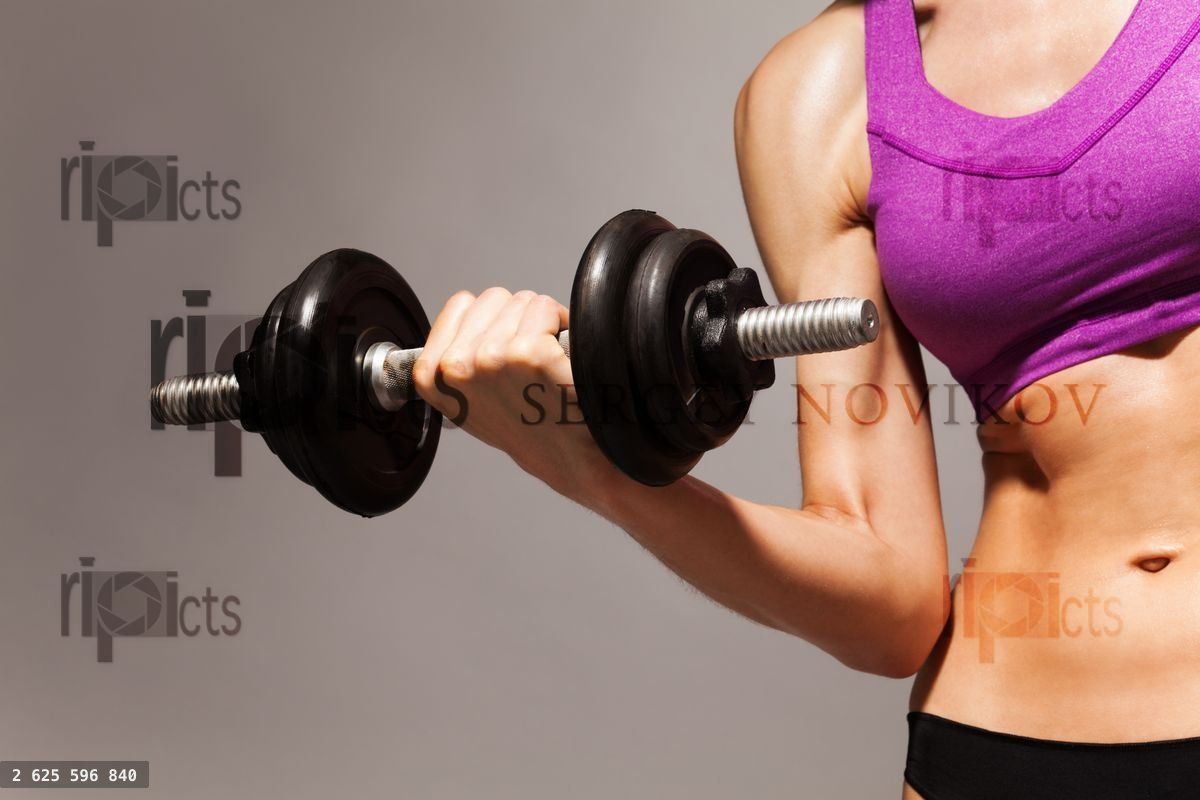 Woman hold dumbbell with strong hand and fit body