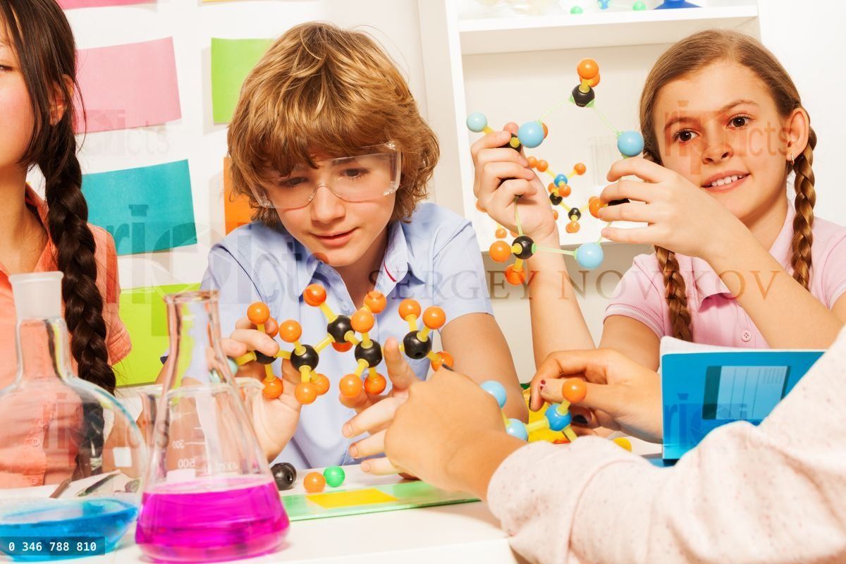 Young students studying molecular structure at lab