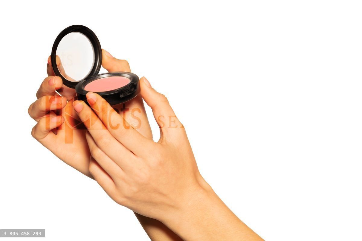 Woman's hands holding opened blusher case on white