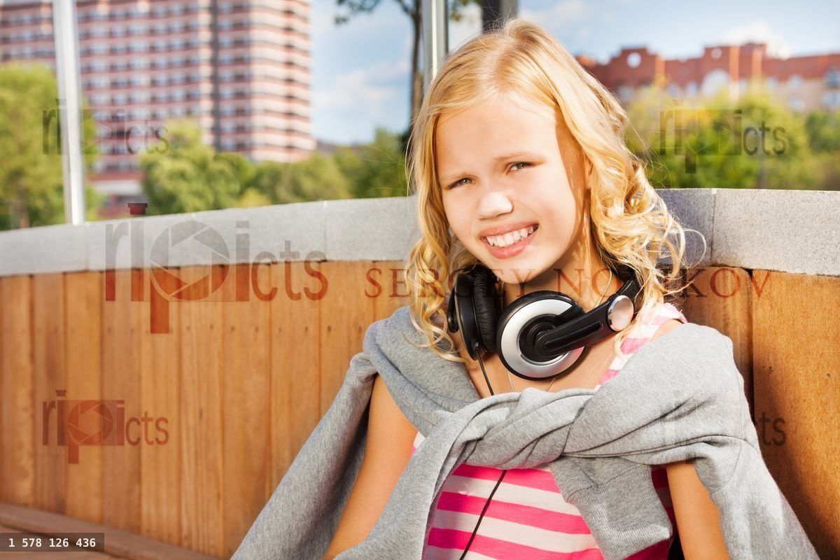 Close view of girl wearing headphones, sweatshirt
