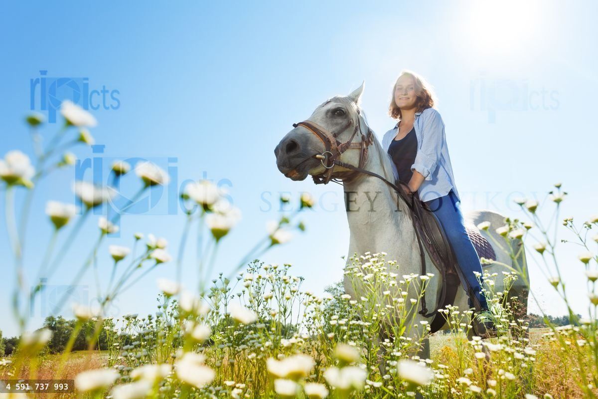 Young woman horseriding beautiful white horse