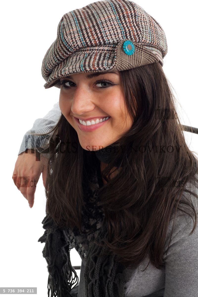 Young woman in cap smile and turn back