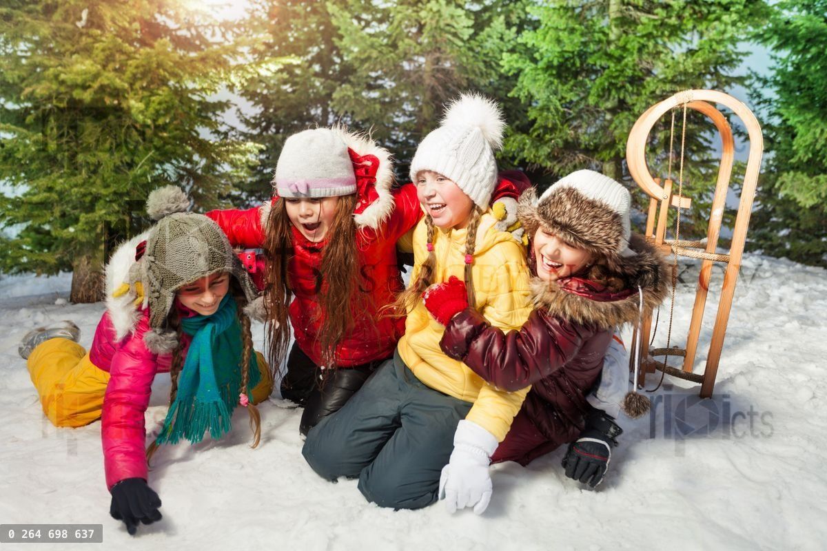 Friends playing together at winter games on snow