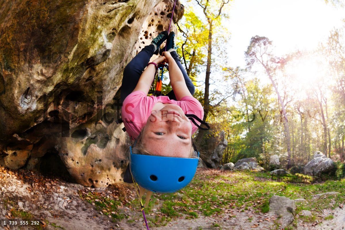 Girl having fun during rock climbing training