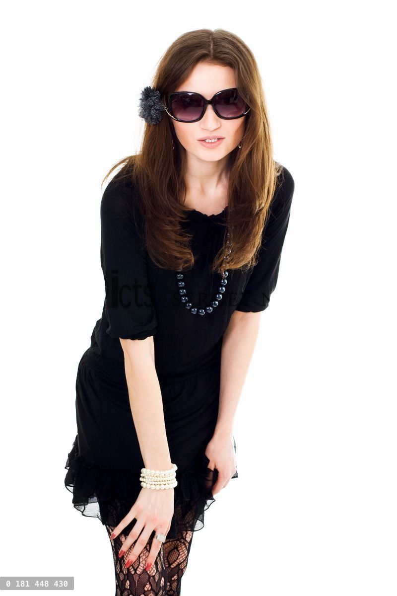 Woman in black dress and sunglasses