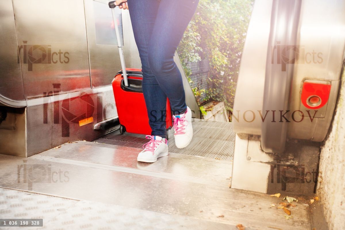 Women's shoes going up on the escalator outdoors