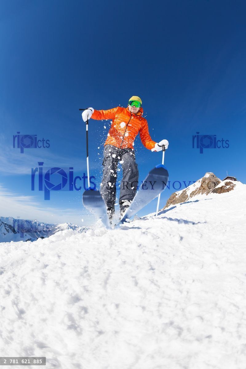 Young man skiing in motion view from below