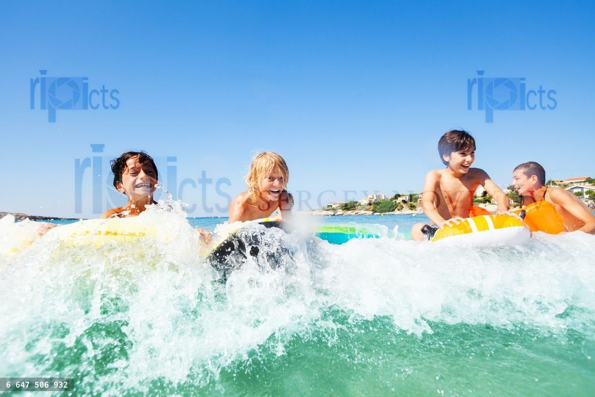 Young surfers riding the waves on body boards