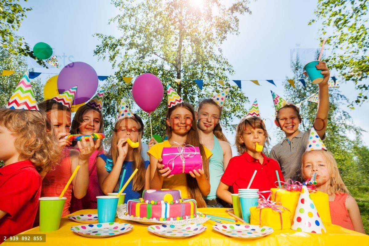 Funny kids cheering birthday girl at summer park