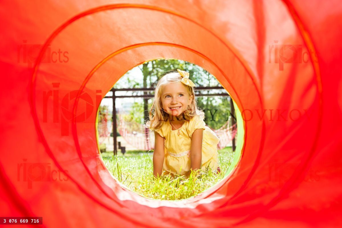 Blond beautiful girl crawling though the tube