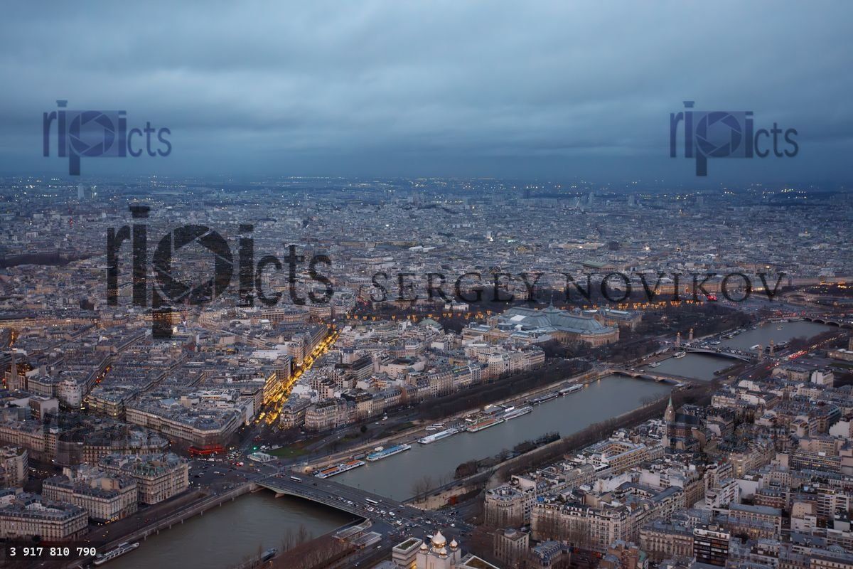 Capital of France skyline facing a river Seine at winter dusk