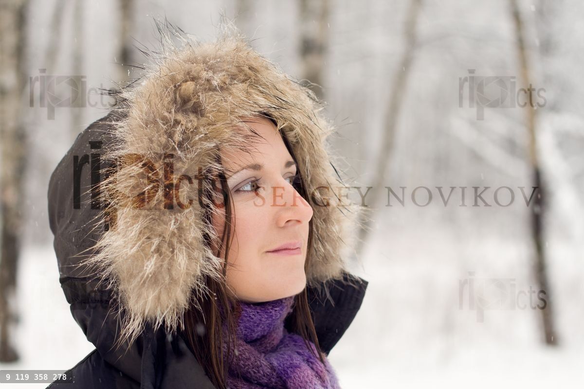 Woman in forest with fur hood