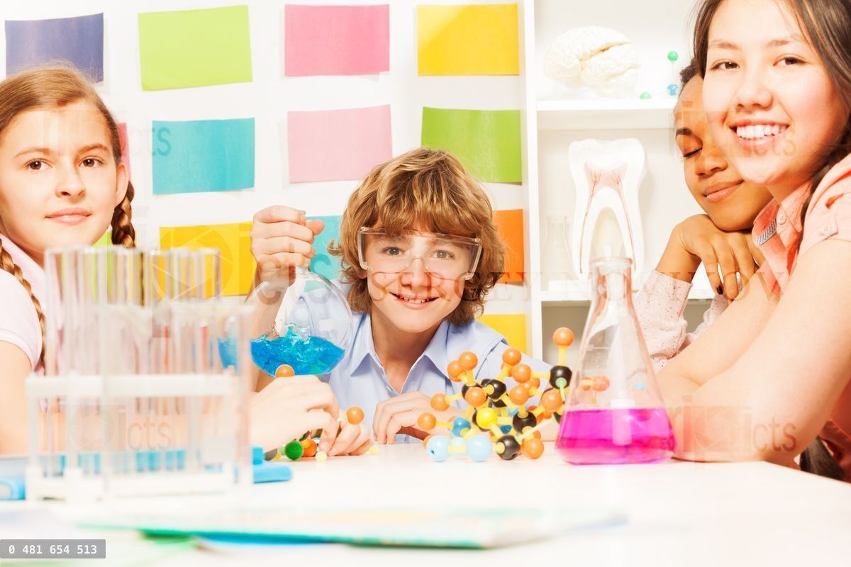 Four young students doing a chemistry experiment