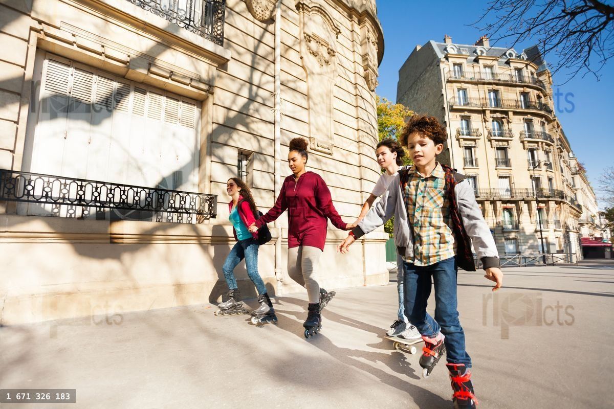 Friends rolls at the sidewalk of autumn city