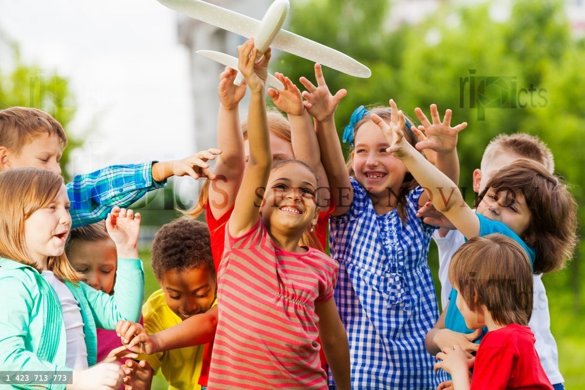 Close up view of kids reaching after airplane toy