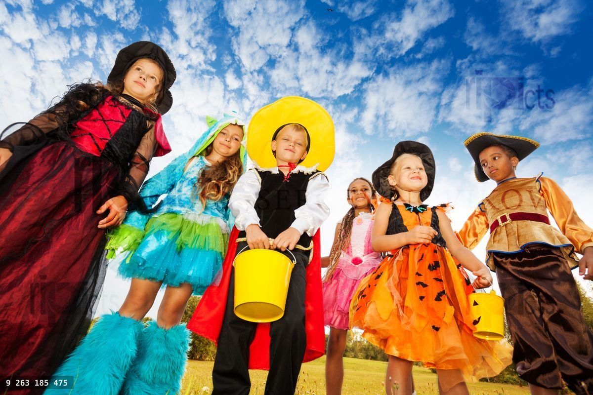 Group of kids in Halloween costumes looks down