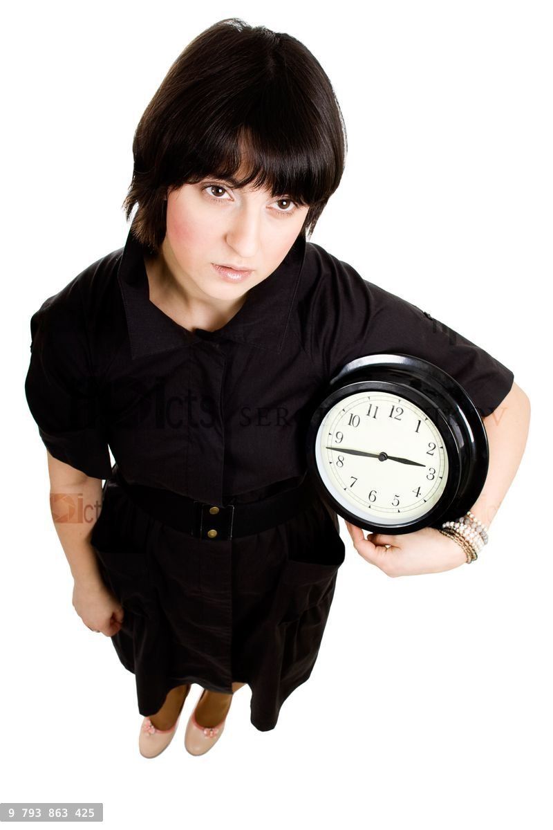 Cacasian woman holding wall clock