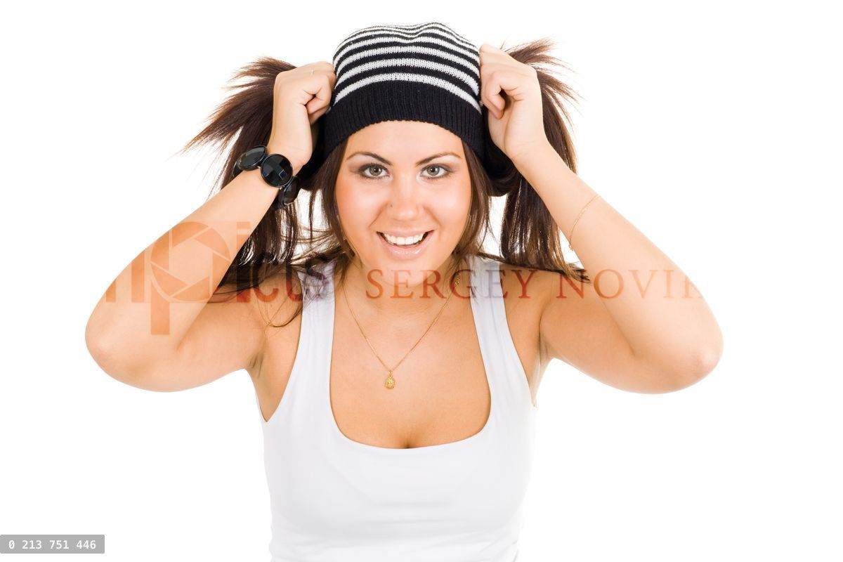 Young woman smiling and holding her ponytails