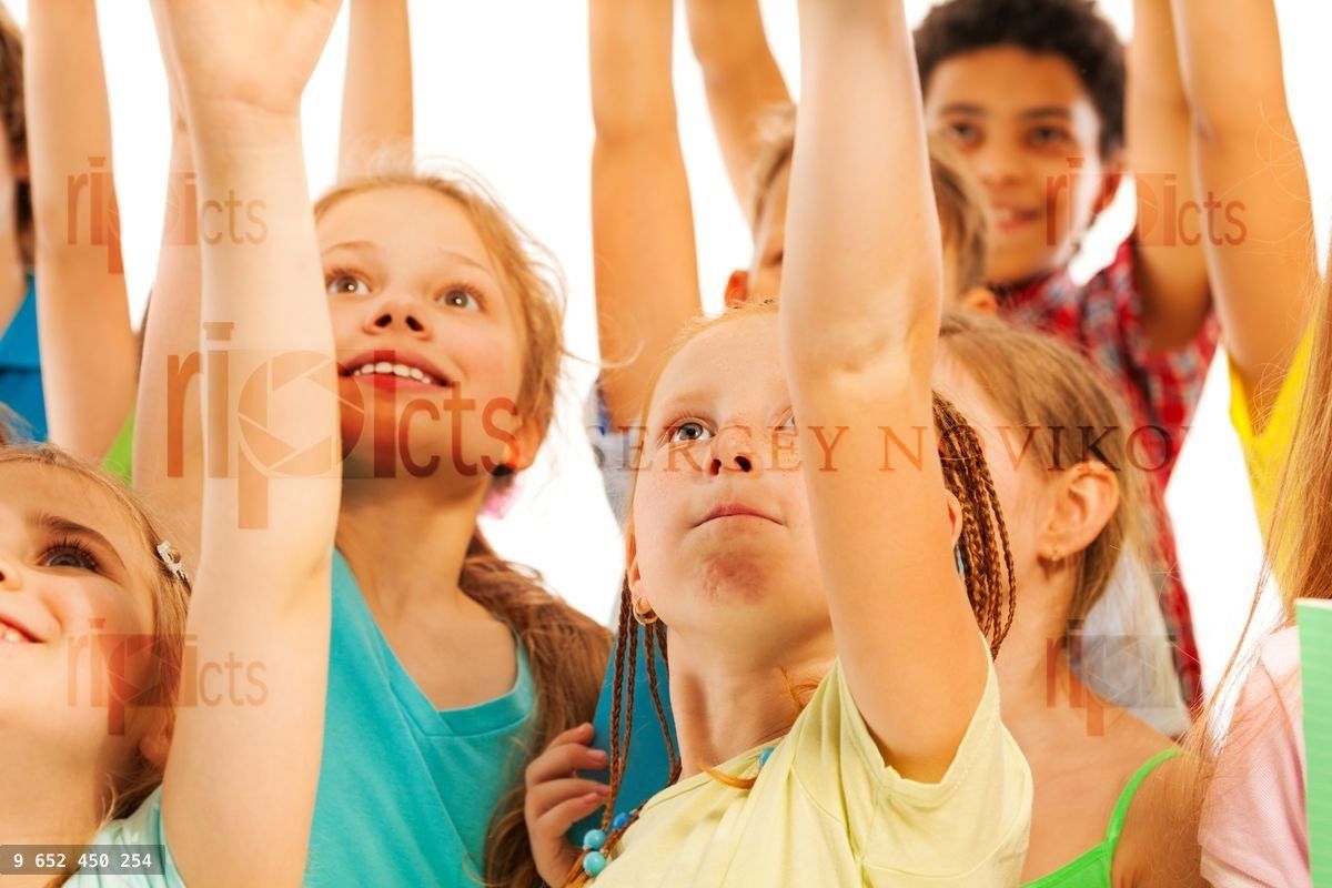 Les enfants dans la foule sourient et lèvent les mains