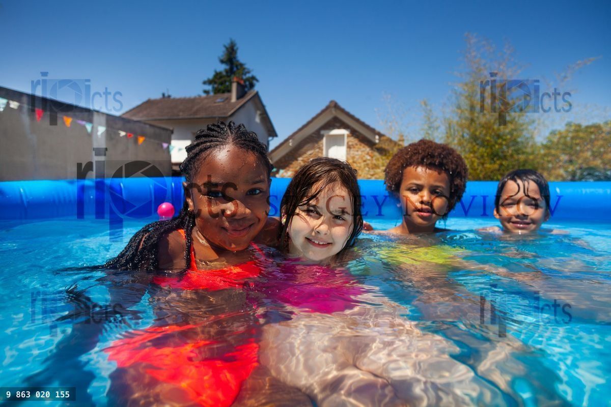 Group small kids friends in swimming pool together