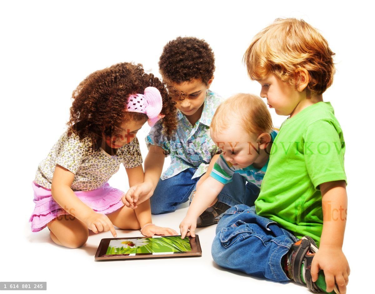 Four little kids playing tablet