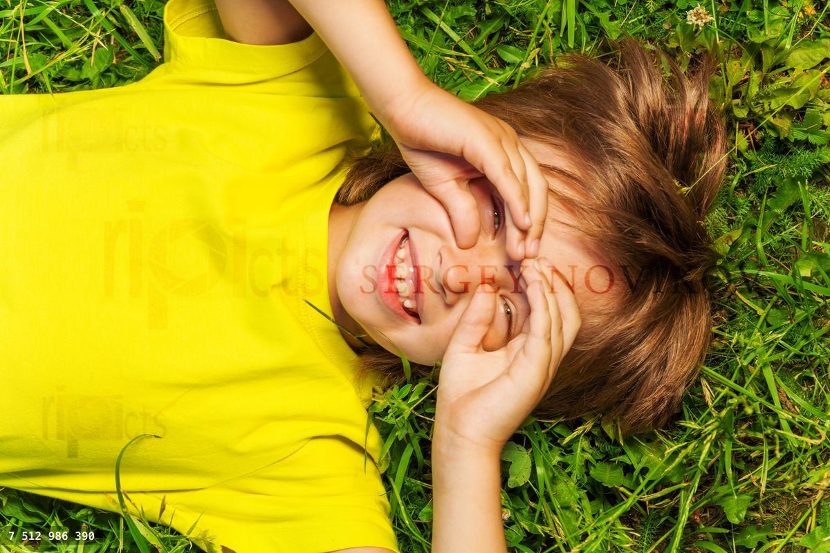 Funny boy with hands on face in glasses shape