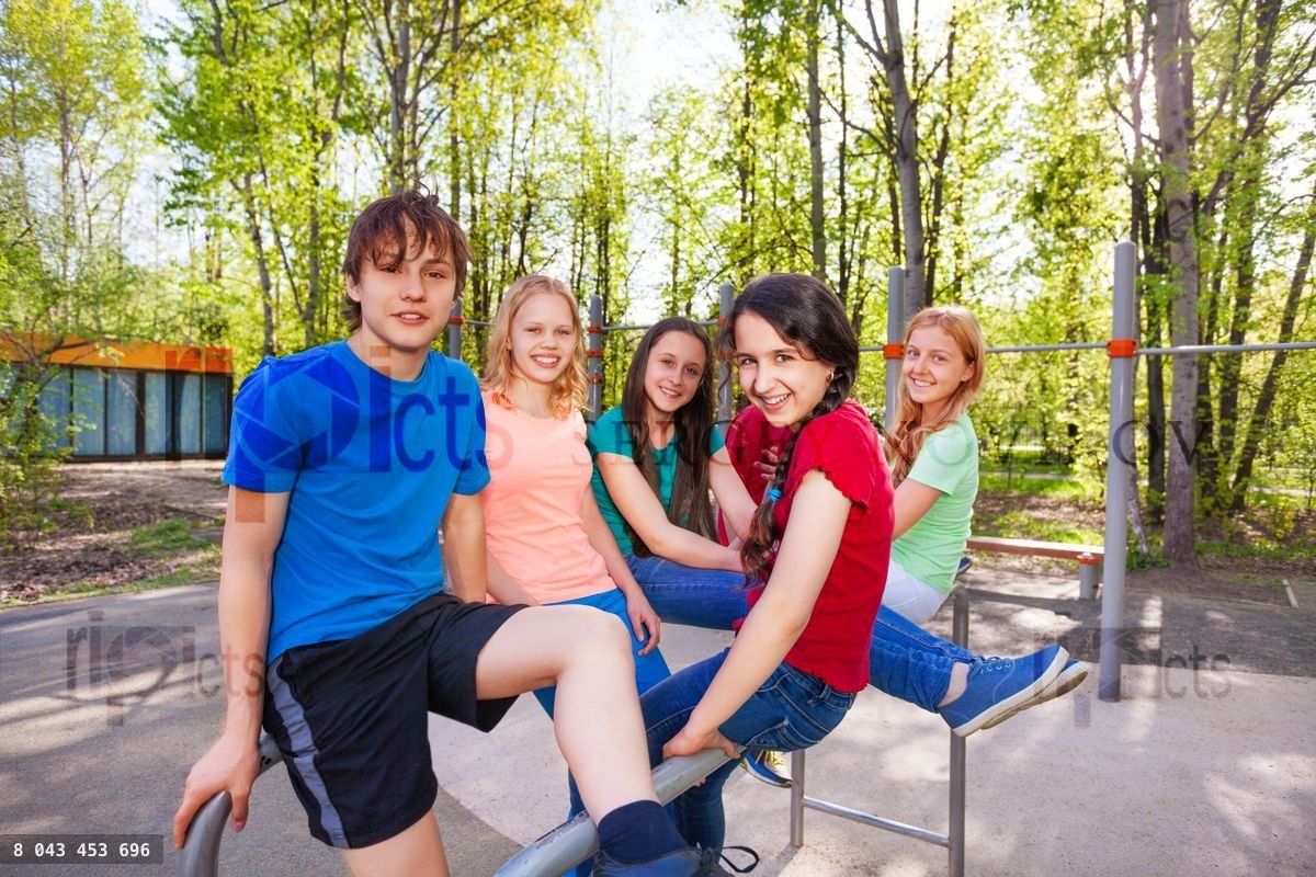 Friends sitting on brachiating at the playground